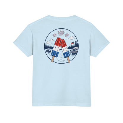 Light blue t-shirt with a graphic of two popsicles and fireworks on the back, on a white background.